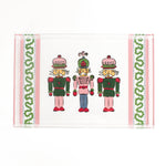 Three Nutcrackers on white background bordered with pink, blue, and green acrylic trays in small size.