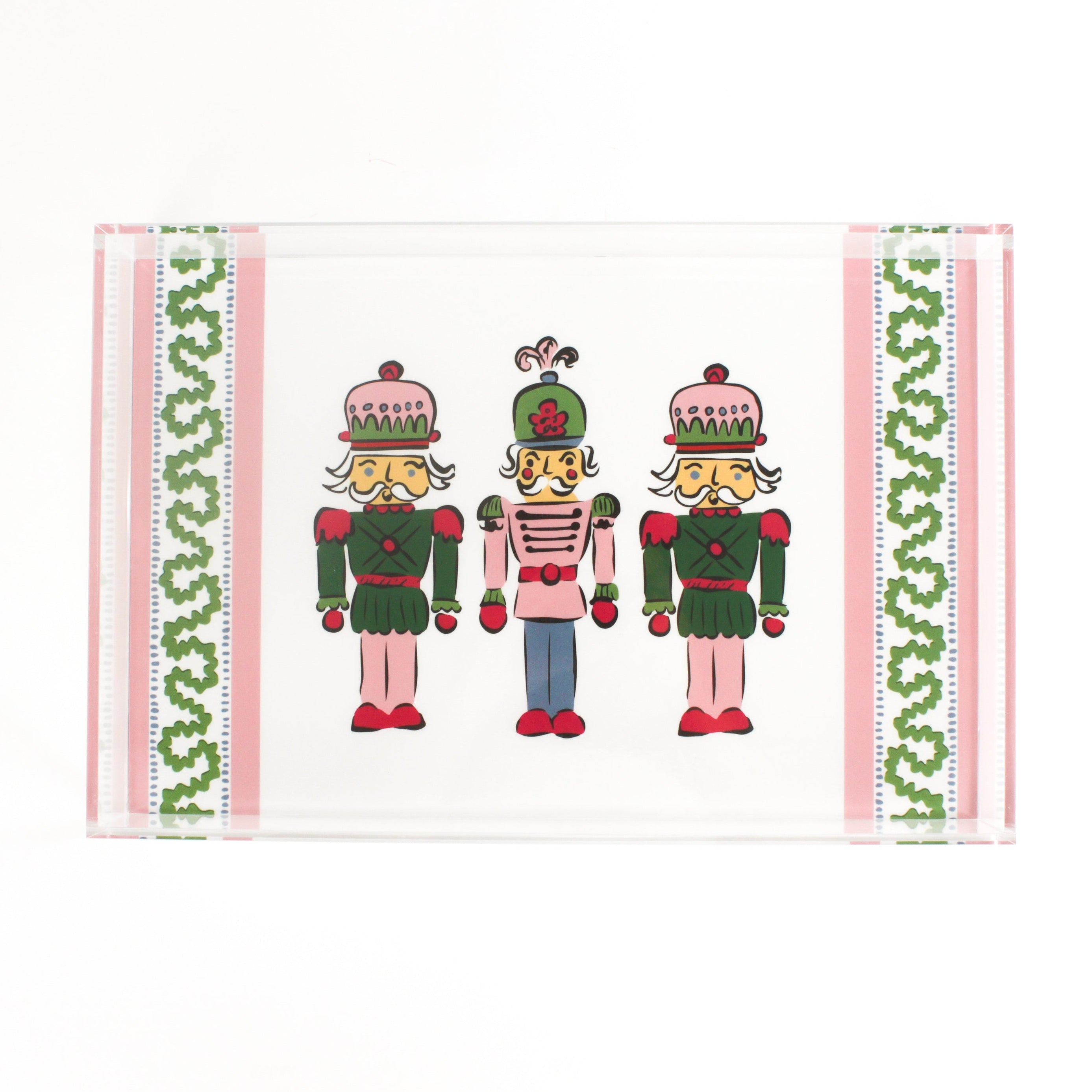 Three Nutcrackers on white background bordered with pink, blue, and green acrylic trays in small size.