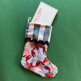 A lobster print red and blue Christmas stocking with a folded gingham top