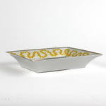 side view of the Madcap Cottage yellow and white porcelain trinket tray with a gold border and a saying that says Tell Stories.