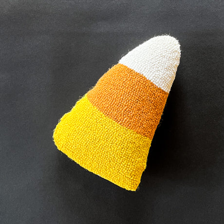 Madcap Cottage candy corn themed Halloween throw pillow on a black background