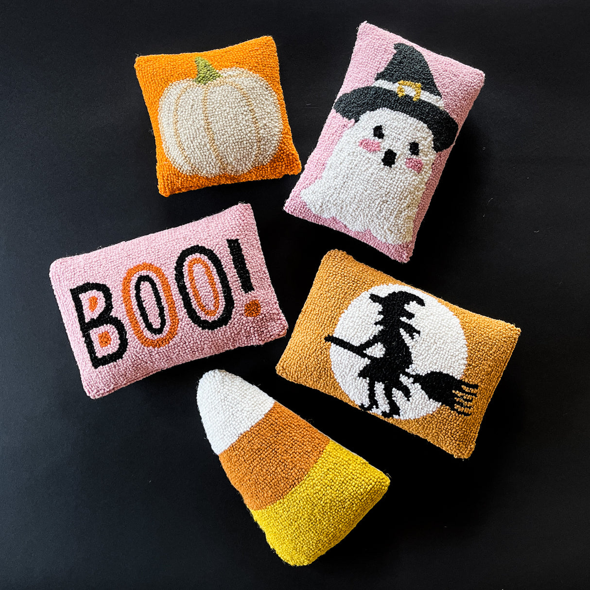 Madcap cottage halloween throw pillows that feature a pumpkin motif, a witch motif, a candy corn, ghost witch and boo!