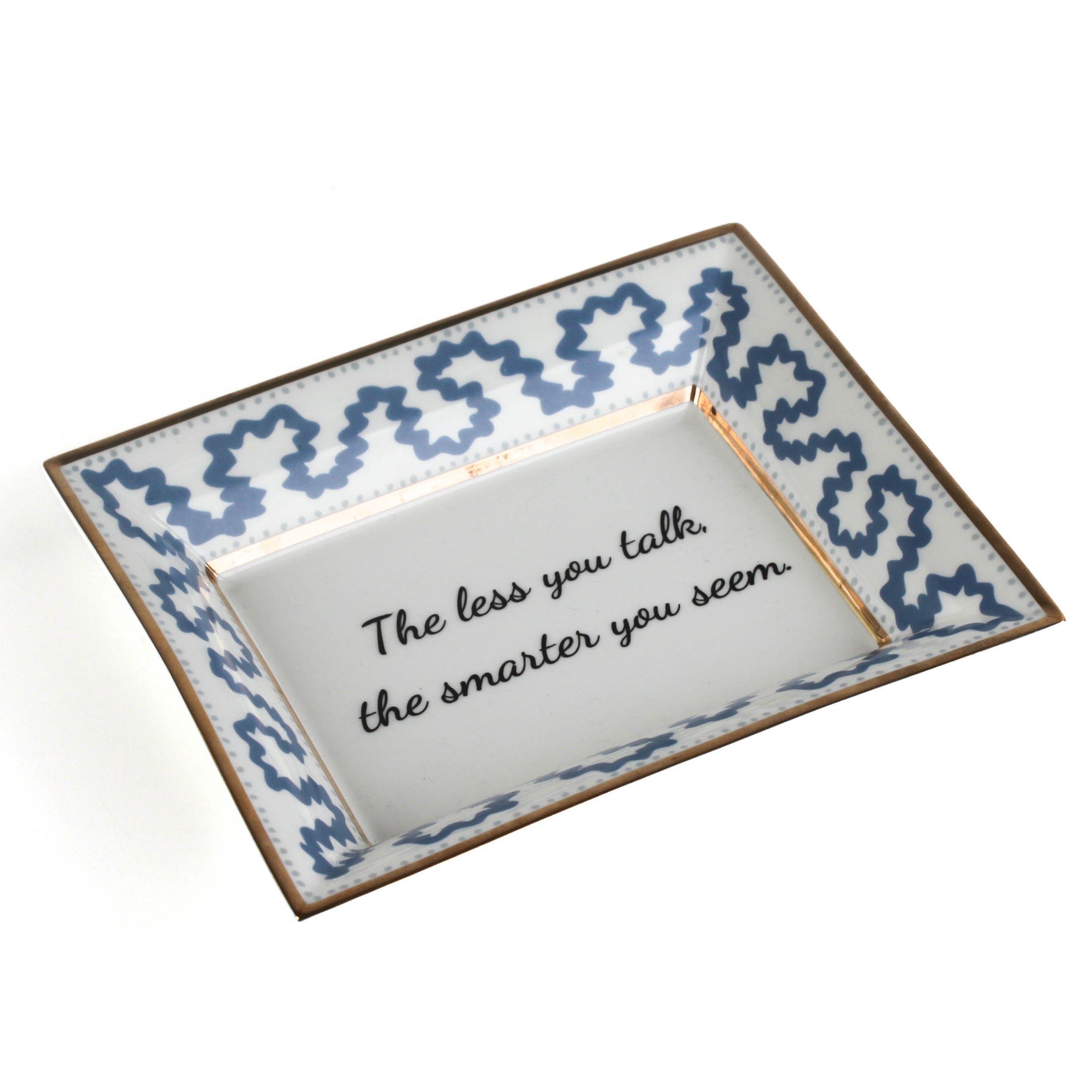 Madcap Cottage blue and white trinket tray with a gold border and a saying that says The less you talk, the smarter you seem. 