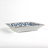 side view of the Madcap Cottage blue and white trinket tray with a gold border and a saying that says The less you talk, the smarter you seem. 