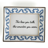 Madcap Cottage blue and white trinket tray with a gold border and a saying that says The less you talk, the smarter you seem. 