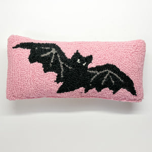 A pink wool lumbar halloween accent pillow with black bat design front