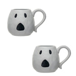 White ceramic mugs with a jack o'lantern design, one with a handle
