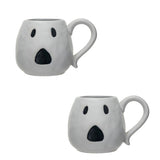 White ceramic mugs with a jack o'lantern design, one with a handle