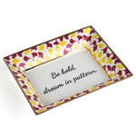 Madcap cottage rhubarb pink and yellow trinket tray with the saying be bold, dream in pattern.
