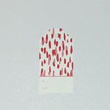 A red gift tag with a geometric pattern, displayed on a white background