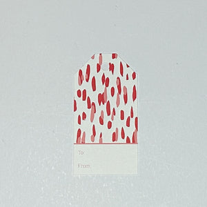 A red gift tag with a geometric pattern, displayed on a white background