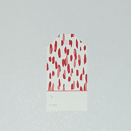A red gift tag with a geometric pattern, displayed on a white background