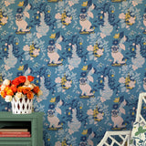 A green table against a wall of blue and white chinoiserie wallpaper with a pug motif.