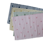 four cotton washable accent rugs from madcap cottage in navy blue, yellow, green and pink featuring a repeating daisy motif.