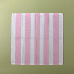 a pink striped napkin with an additional light green dotted stripe