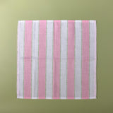 a pink striped napkin with an additional light green dotted stripe
