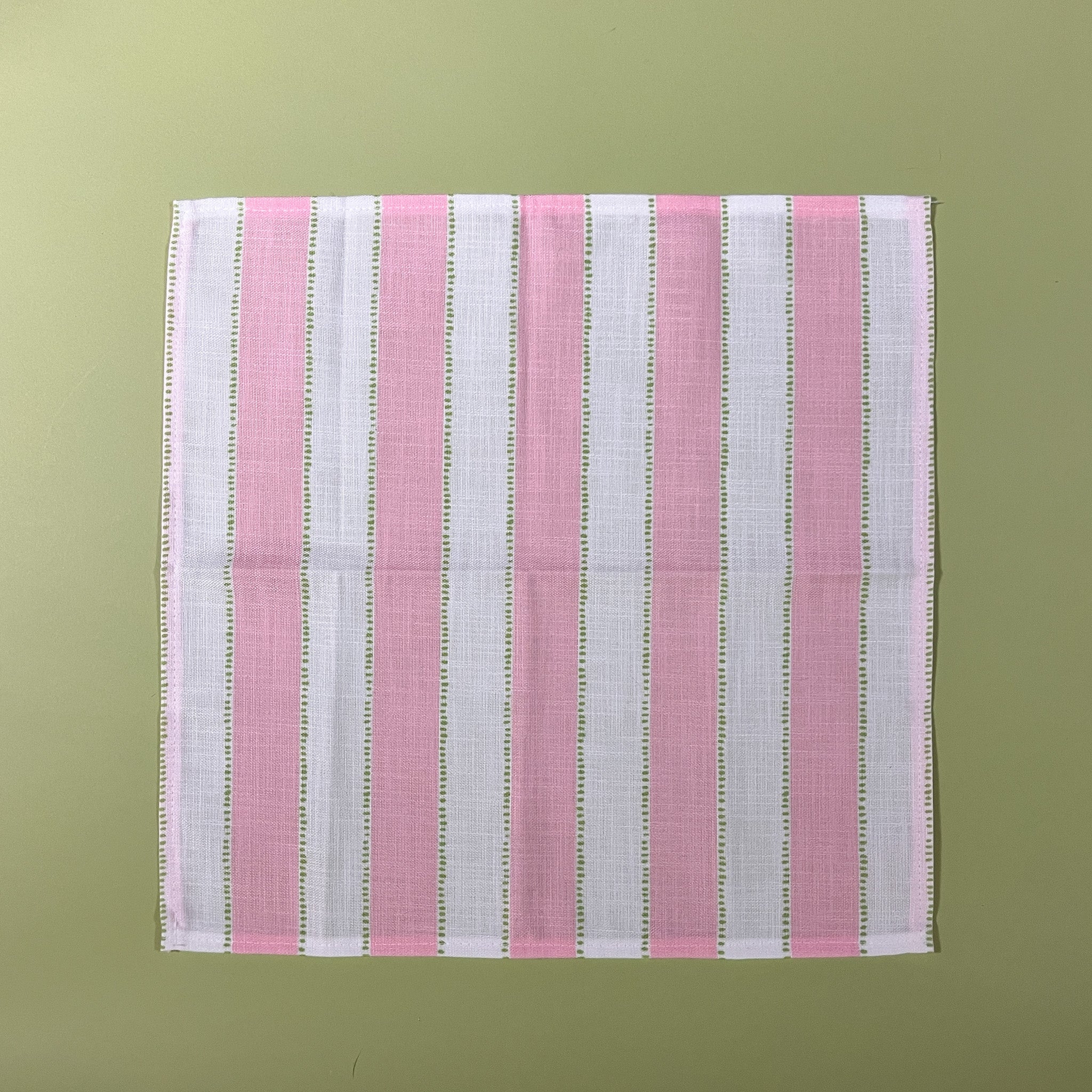 a pink striped napkin with an additional light green dotted stripe