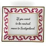 Madcap cottage pink and white porcelain trinket tray with a gold border and a saying that says If you want to be neutral move to Switzerland.