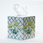 a white and green tissue box cover from madcap cottage with a central yellow geranium pattern on each side. 