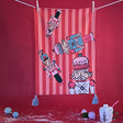 Four Nutcrackers on Pink and Red Stripe Background Tea Towel