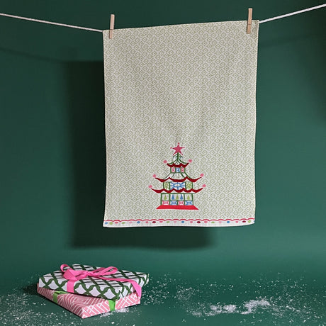Christmas Pagoda Tea Towel with some embroidery on green and white background