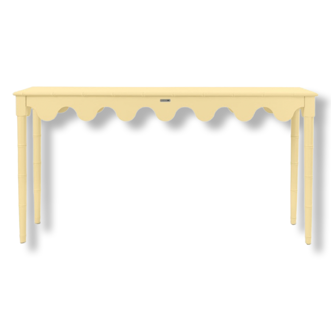 A yellow console table with scalloped edges