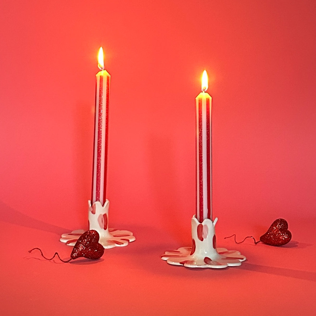 Red and white sparkly taper candles.