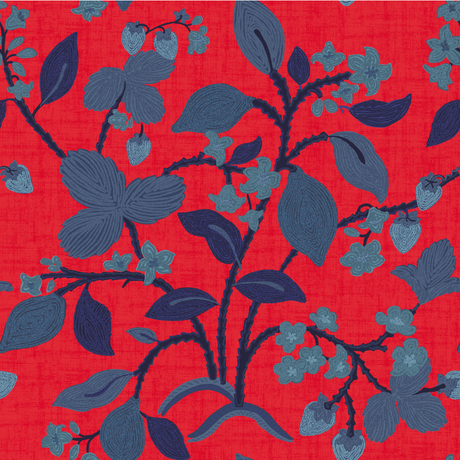 a strawberry fabric sample featuring colorful strawberry and lemon motifs on a red background