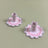 A pair of Scalloped ceramic candle holders with a pink and green wavy motif 
