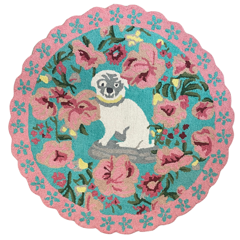 A pink and green floral rug featuring a scalloped border and large central pug motif
