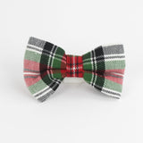a McNixon Red/White/Dark Green Plaid Dog/Cat Bowties in Large placed on a white surface
