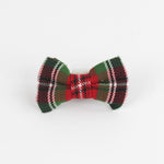 a McNixon Red/White/Dark Green Plaid Dog/Cat Bowties in Medium placed on a white surface