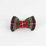 a McNixon Red/White/Dark Green Plaid Dog/Cat Bowties in Medium placed on a white surface