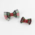 2 McNixon Red/White/Dark Green Plaid Dog/Cat Bowties in Medium and Large placed on a white surface