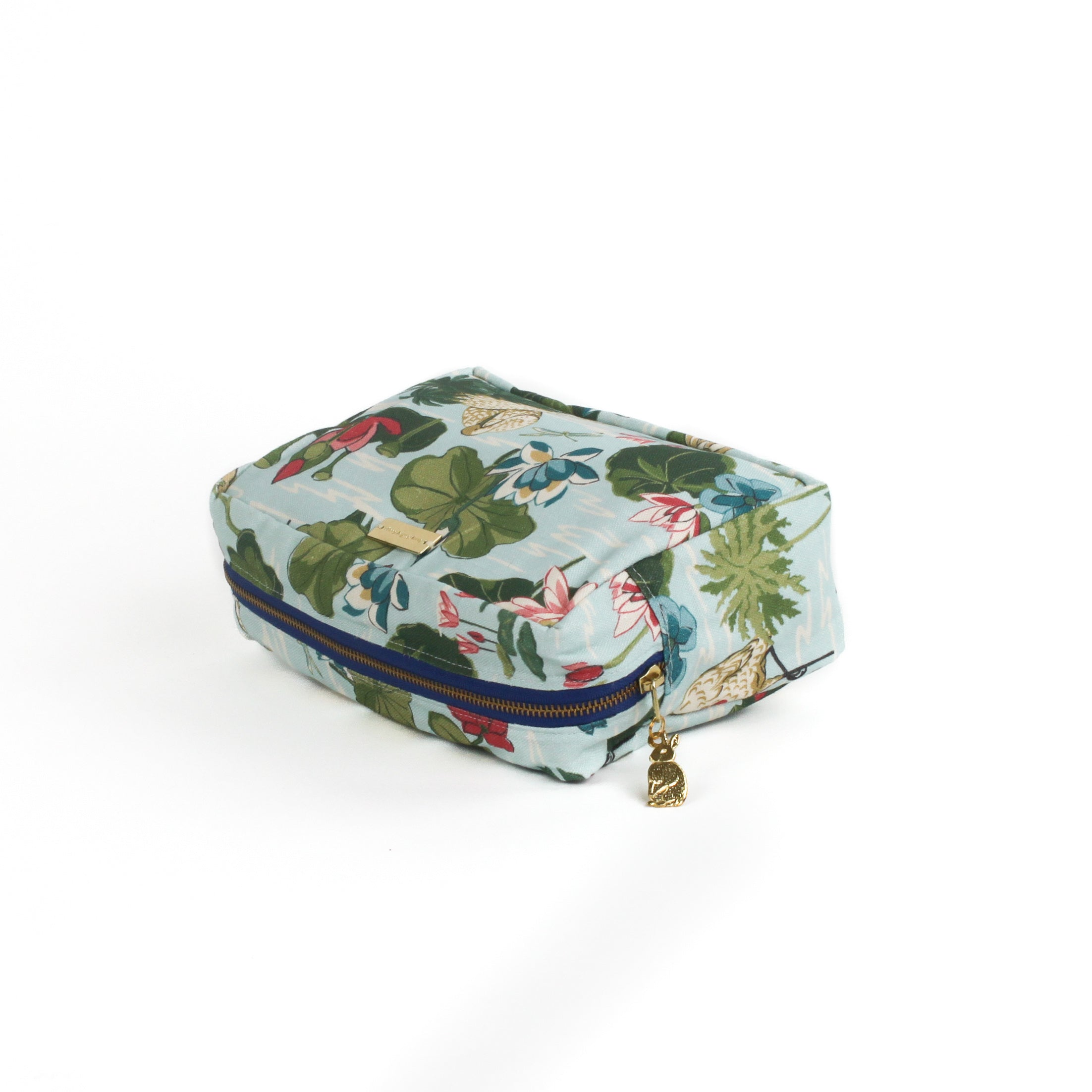 Meadow Club toiletry bag in sky blue features a lily pond pattern in a white background