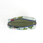 Meadow Club toiletry bag in sky blue features a lily pond pattern in a white background