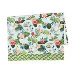 a green and blue floral tea towel with heron and waterlily motifs against a white background. 