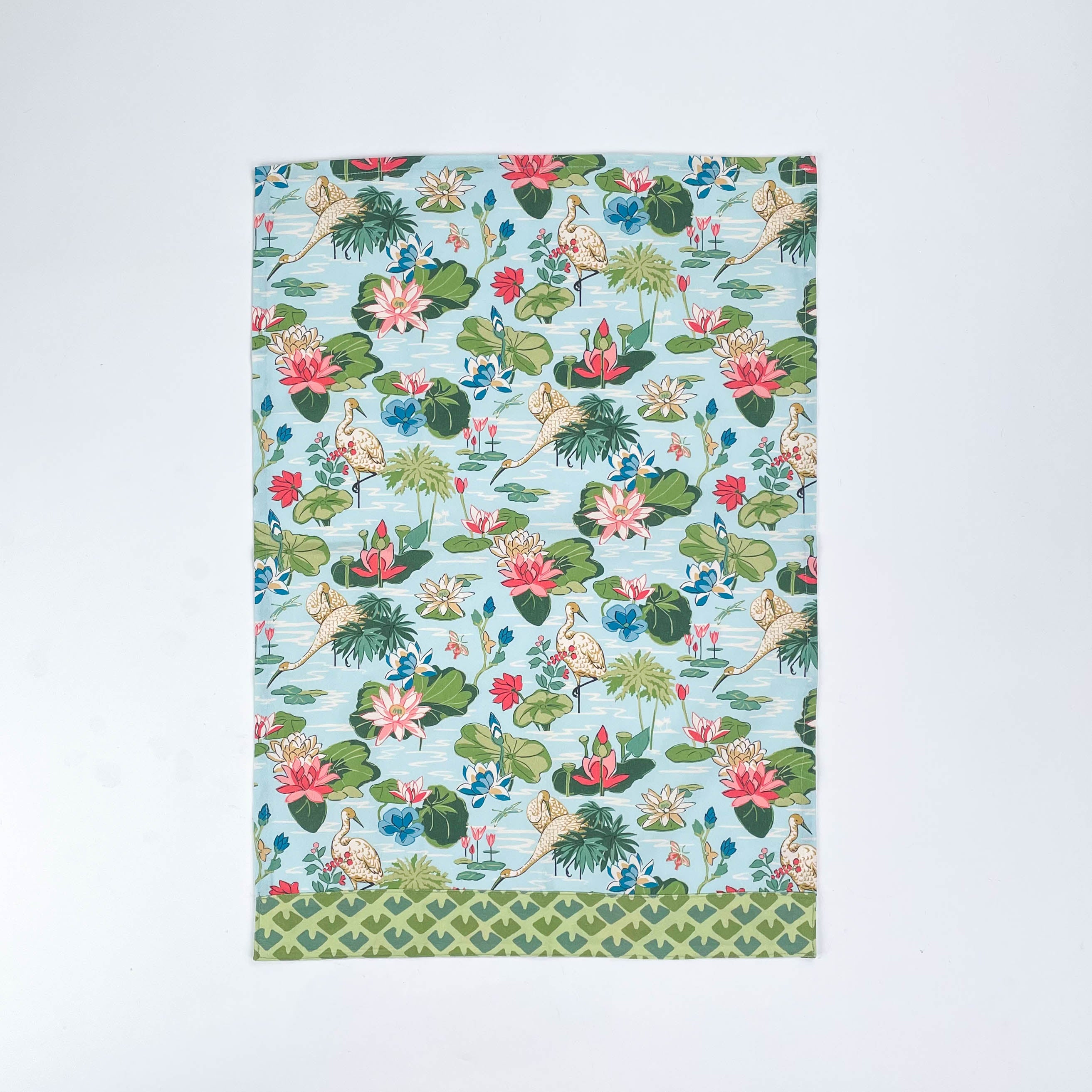 Floral Christmas tea towel featuring water lily and herom motifs