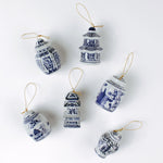 Elegant blue and white porcelain Christmas chinoiserie ginger jar ornaments on a white background. 