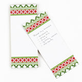 Notepad with decorative green and red border on a white background