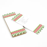 Notepad with decorative green and red border on a white background