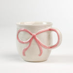 Ceramic pink Bow Mug in a white background