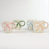 4 multicolored Ceramic Bow Mugs in a white background