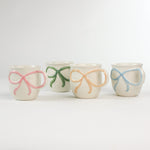 4 Multicolored Ceramic Bow Mugs in a white background
