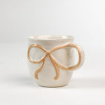 Ceramic yellow Bow Mug in a white background