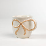 Ceramic yellow Bow Mug in a white background