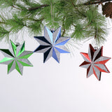 Set of three glittered star Christmas ornaments in assorted metallic colors