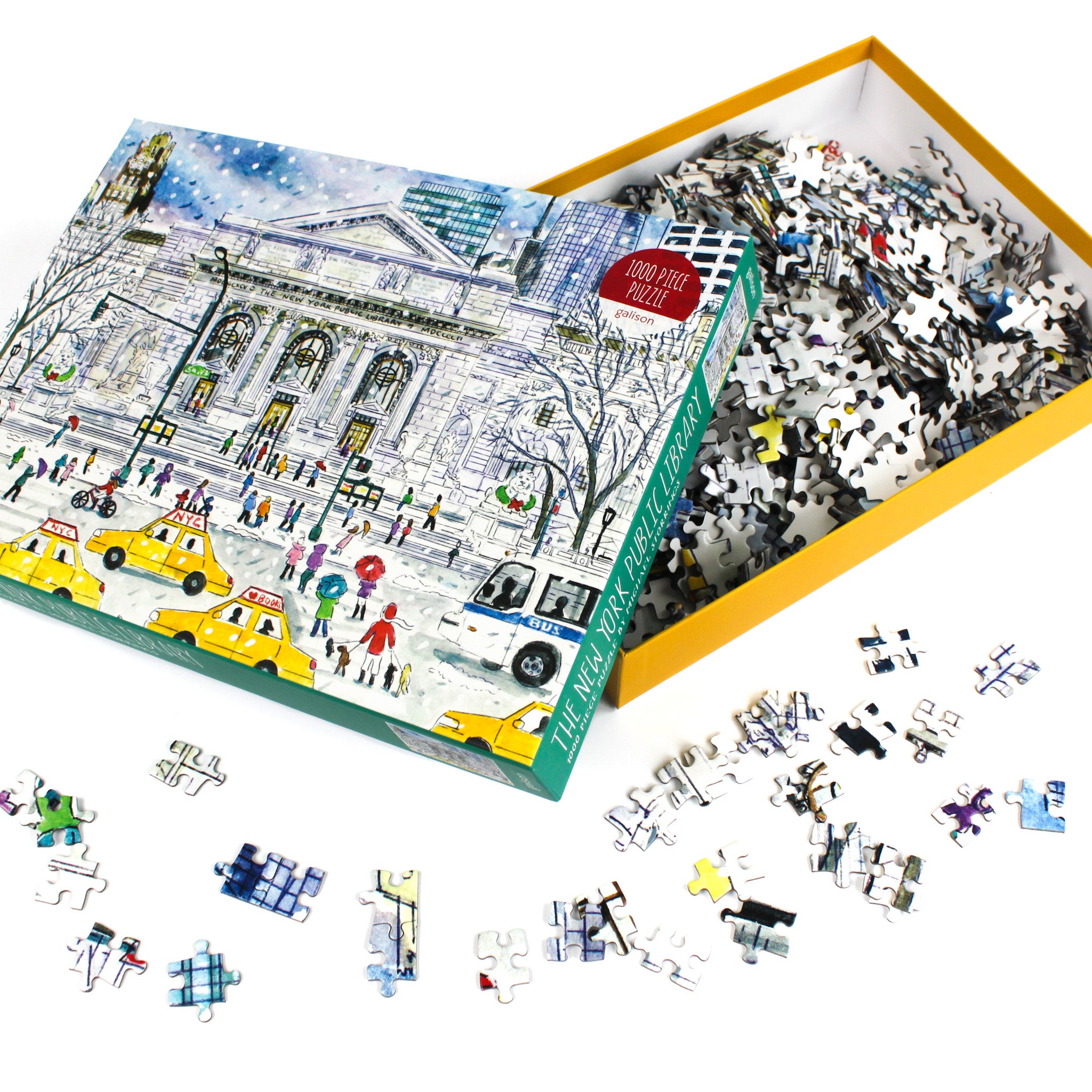 1000-piece jigsaw puzzle featuring the New York Public Library winter illustration by Michael Storrings, shown with an open yellow box filled with loose puzzle pieces scattered around.