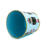 Light blue tole cachepot with gold trim and nutcracker design, shown on its side revealing interior.