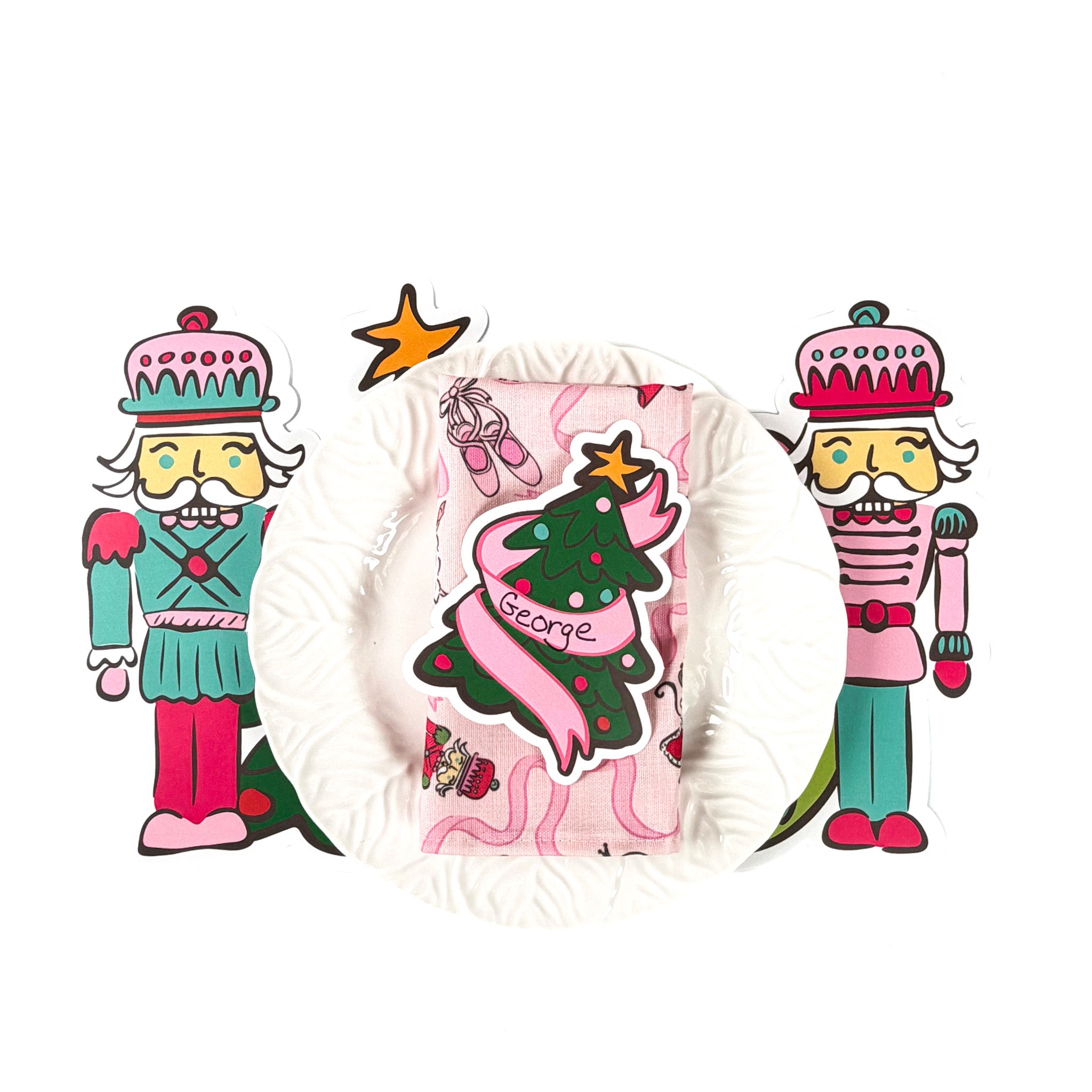 Christmas tabletop entertaining display featuring nutcracker cutout decorations, a white ruffled plate, and a pink holiday napkin with personalized Christmas tree design, arranged on a white background.